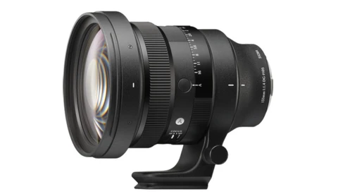 Black telephoto lens with manual focus ring and depth-of-field scale mounted on tripod collar.