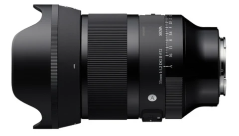 Telephoto zoom lens with attached lens hood, shown from the side against a white background.