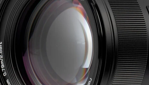 Close-up view of a camera lens showing internal glass elements and optical construction.