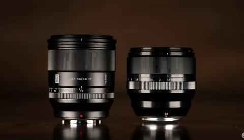 Two camera lenses side by side against a brown background, the left lens noticeably larger than the right.
