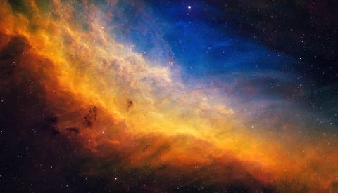 Nebula with fiery orange and golden clouds transitioning to deep blue, dotted with stars.