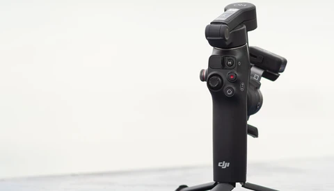 DJI gimbal stabilizer mounted on stand against white background.