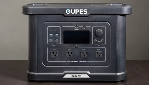 OUPES portable power station with 2232Wh capacity and four AC outlets displayed on brown surface.