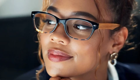Woman wearing tortoiseshell-frame glasses with a natural, confident expression.
