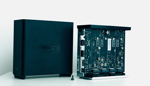 TerraMaster NAS device shown closed and with internal circuit board exposed.