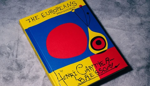 Book cover with bold primary colors featuring a large red circle on blue background and yellow border with handwritten text.