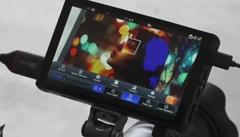 Screenshot of video editing software interface displaying colorful bokeh footage with adjustment panels and timeline controls.