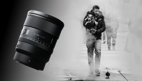 Telephoto zoom lens positioned next to black and white photograph of person jogging through misty street.