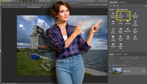 Screenshot of photo editing software showing composite image of woman pointing at industrial building by water.