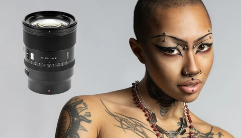 Portrait of a person with artistic makeup and tattoos, shown alongside a telephoto camera lens.