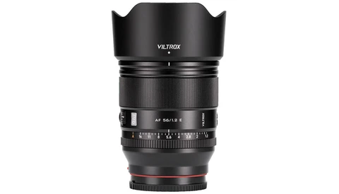 Viltrox AF 56/1.5 E prime lens with hood mounted and aperture ring visible against white background.