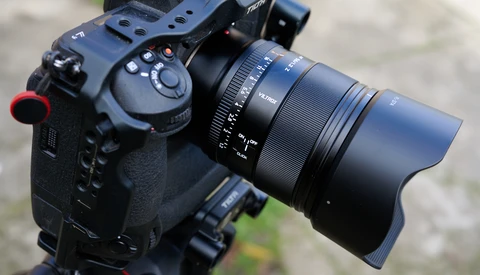 Professional cinema camera with attached zoom lens and wireless focus control mounted on a rig.