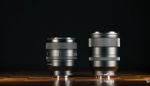 Two silver camera lenses of different sizes positioned side by side against a dark background.
