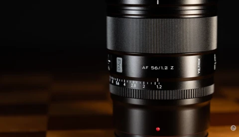 Zeiss AF 56/1.2 Z lens with focus ring and aperture markings visible against dark background.