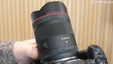 Canon RF 14mm f/1.4L USM lens held in hand during product demonstration.