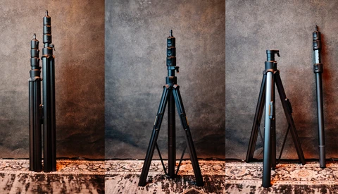Four telescoping camera tripods displayed in different extended positions against a textured backdrop.