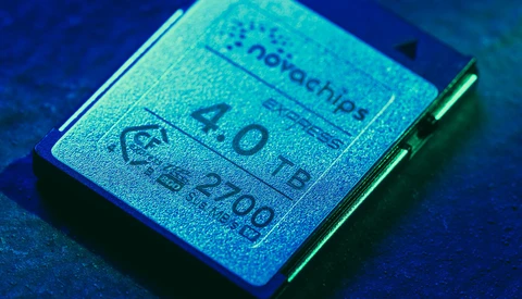 Close-up of a computer processor chip with visible text and specifications under blue-tinted lighting.