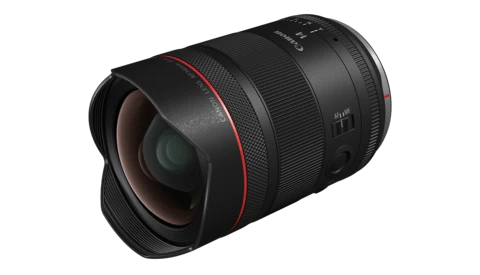 Wide-angle camera lens with black barrel and red accent ring on white background.
