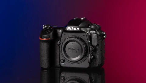 Nikon D60 DSLR camera body displayed against a blue and red gradient background.