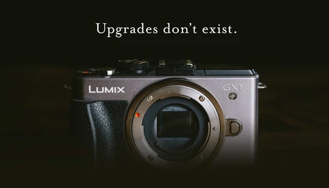Panasonic Lumix GX1 mirrorless camera body against dark background with text overlay.