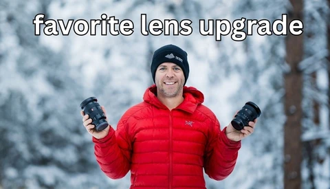 Photographer holding two telephoto lenses in snowy forest setting wearing red jacket.