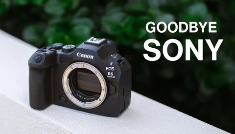 Canon EOS R6 Mark II mirrorless camera body with exposed sensor mount against blurred green foliage background.