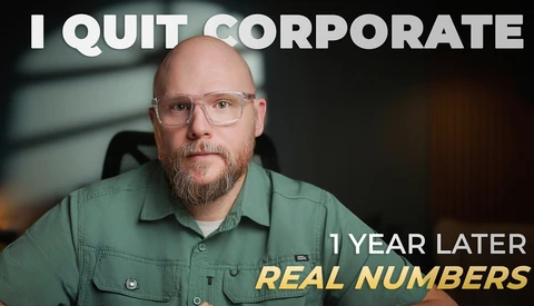 Man in green shirt with glasses looking at camera in indoor office setting.