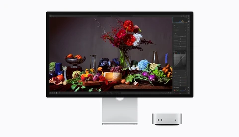 Screenshot of color-grading software displaying a vibrant still life of flowers, produce, and glassware on a dark surface.