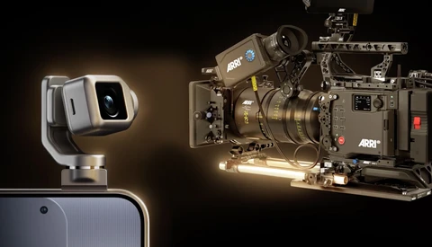 Professional cinema camera rig with mounted lens and accessory arm beside a compact smartphone gimbal stabilizer.