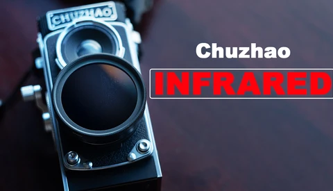 Chuzhao medium-format film camera with infrared lens attachment positioned against a dark background.