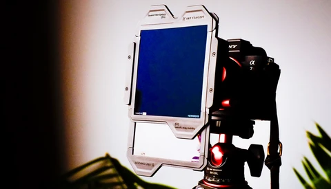 Monitor and camera rig setup on tripod with studio lighting