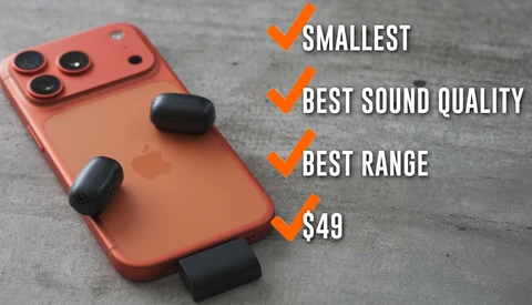 Red smartphone with triple camera setup and three black wireless earbuds displayed against gray surface.