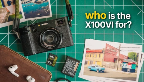 Flat lay of a vintage film camera, printed photographs, memory cards, earbuds, and brown leather pouch on a green cutting mat.