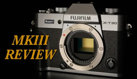 Fujifilm X-T30 mirrorless camera body displayed against black background with yellow review text overlay.