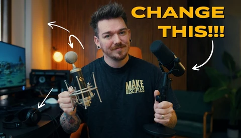 Content creator in studio holding microphone and musical instrument with annotation arrows pointing to equipment.