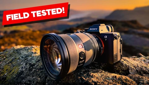 Sony Alpha mirrorless camera with telephoto lens mounted on a rocky outcrop at sunset.