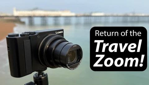 Panasonic Lumix compact camera with extended zoom lens mounted on tripod overlooking coastal pier.