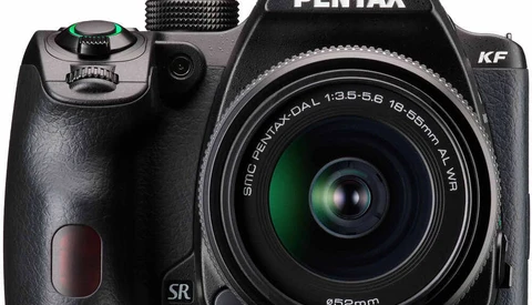 Pentax KF DSLR camera with 18-55mm kit lens on white background