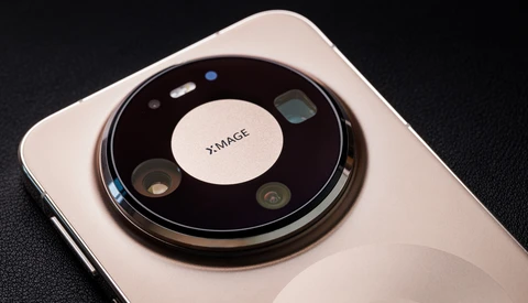 Circular camera module on white smartphone with multiple lenses arranged around center branding.