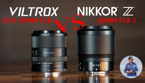 Viltrox Evo 55mm f/1.8 lens positioned beside Nikkor Z 50mm f/1.8 S lens on wooden surface.