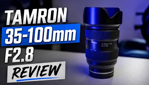 Tamron 35-100mm F2.8 zoom lens with blue accent lighting against dark background.