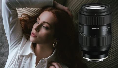 Woman lying on textured bedding with a Tamron lens displayed beside her.