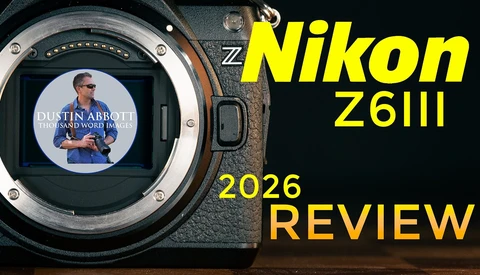 Nikon Z6III camera body with open mirror cavity and LCD screen displaying a tutorial video.
