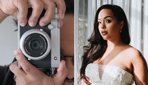 Hands holding a compact rangefinder camera with leather strap and fixed lens.