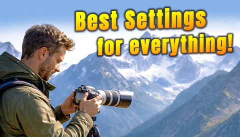 Photographer with telephoto lens photographing snow-capped mountains in bright daylight.