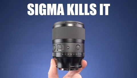 A Sigma lens held in someone's hand against a blue background with white text reading "SIGMA KILLS IT."