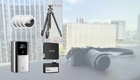Photography equipment collection including smartphone gimbal, wireless microphone system, tripod, camera, and lens displayed against urban cityscape backdrop