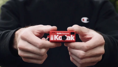 Hands holding a red Kodak Portra film box