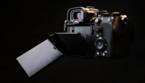 Sony mirrorless camera with articulating touchscreen display tilted outward against black background