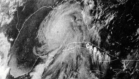Satellite weather imagery showing a hurricane system near Texas and Cuba coastlines